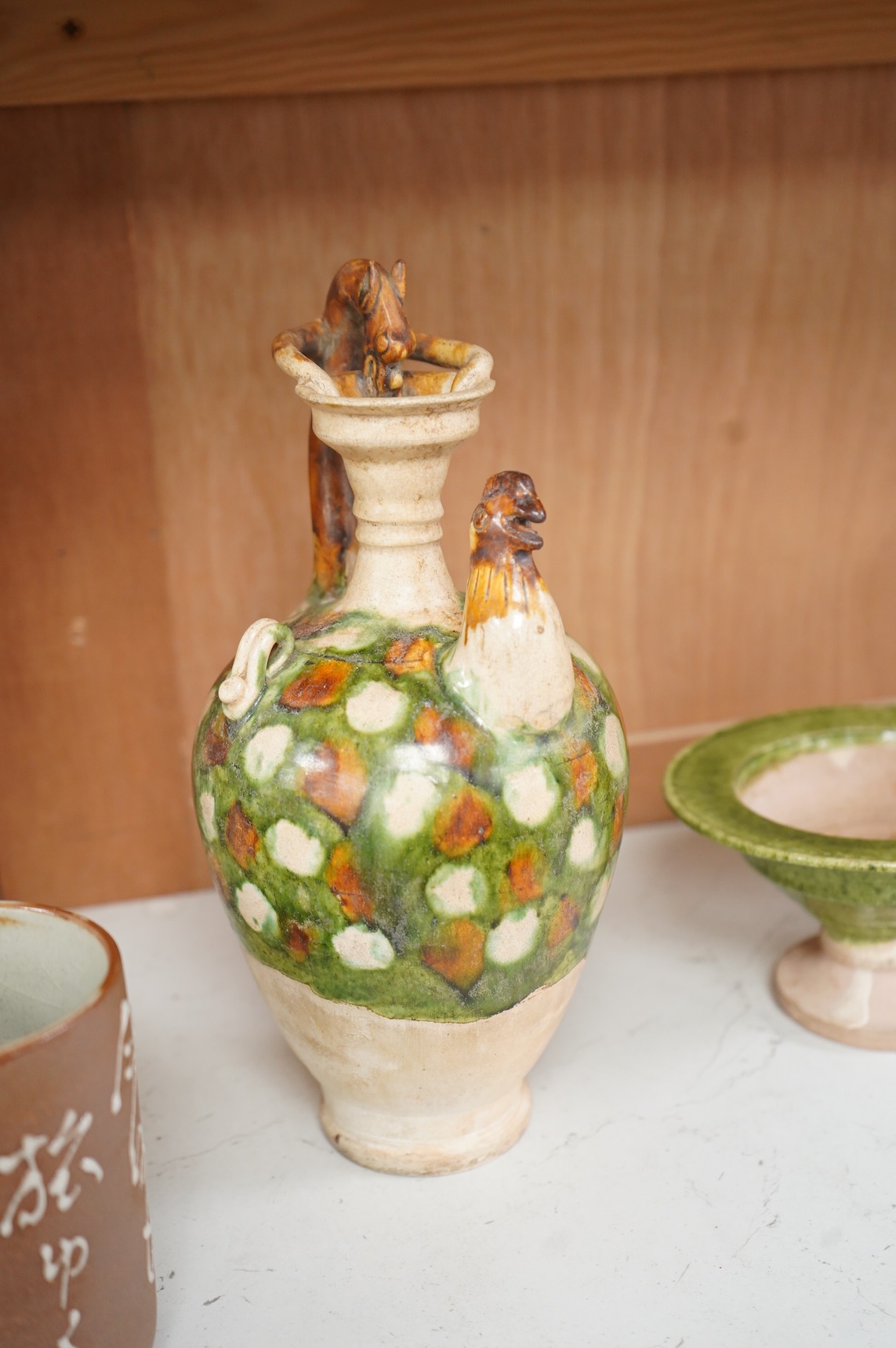 A Chinese agate ware flask, a sancai ewer and a stem dish, largest 26cm high
